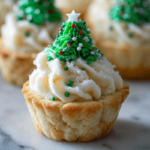Christmas Tree Cream Cheese Cookie Cups decorated with green frosting and sprinkles.